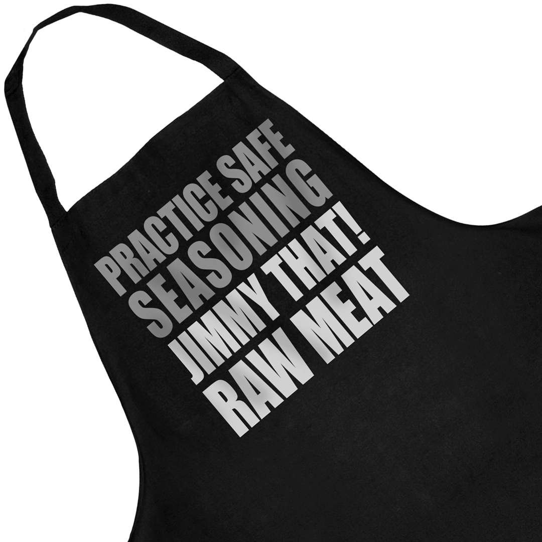 Close-up of the Practice Safe Seasoning print on the black Jimmy That! apron